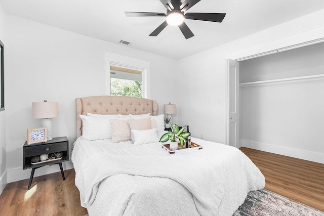 bedroom featuring wood-type flooring, a closet, and ceiling fan