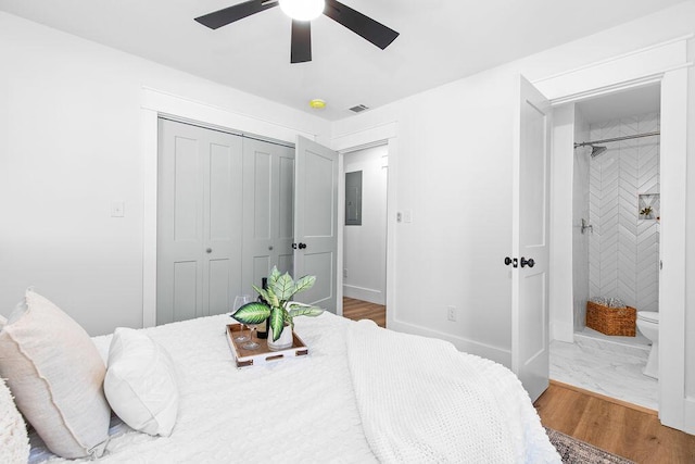 bedroom with ceiling fan, wood-type flooring, and ensuite bathroom