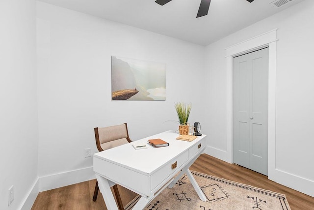 home office featuring light wood-type flooring and ceiling fan