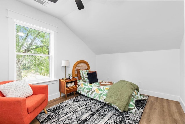 bedroom with ceiling fan, wood-type flooring, and lofted ceiling