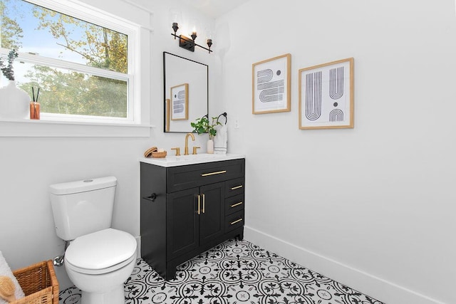 bathroom with tile patterned flooring, vanity, and toilet