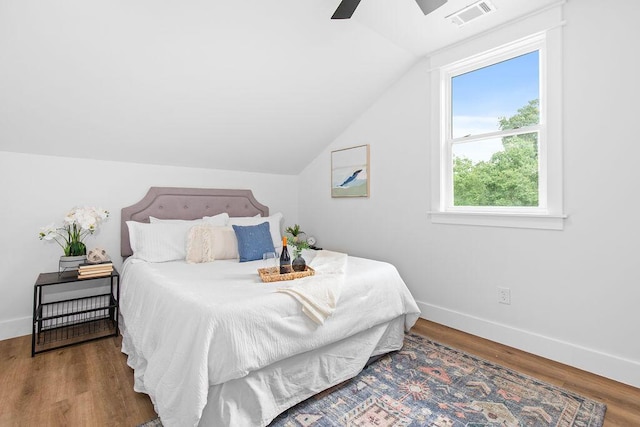 bedroom with multiple windows, ceiling fan, and wood-type flooring