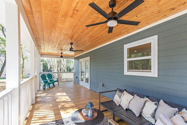 sunroom / solarium with ceiling fan and wood ceiling