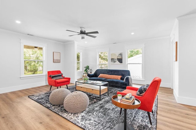 living room with ceiling fan, light wood-type flooring, and crown molding