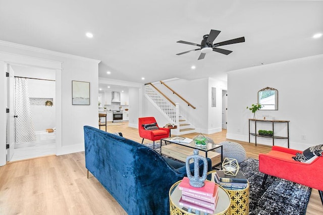 living room featuring ceiling fan, light hardwood / wood-style floors, and ornamental molding