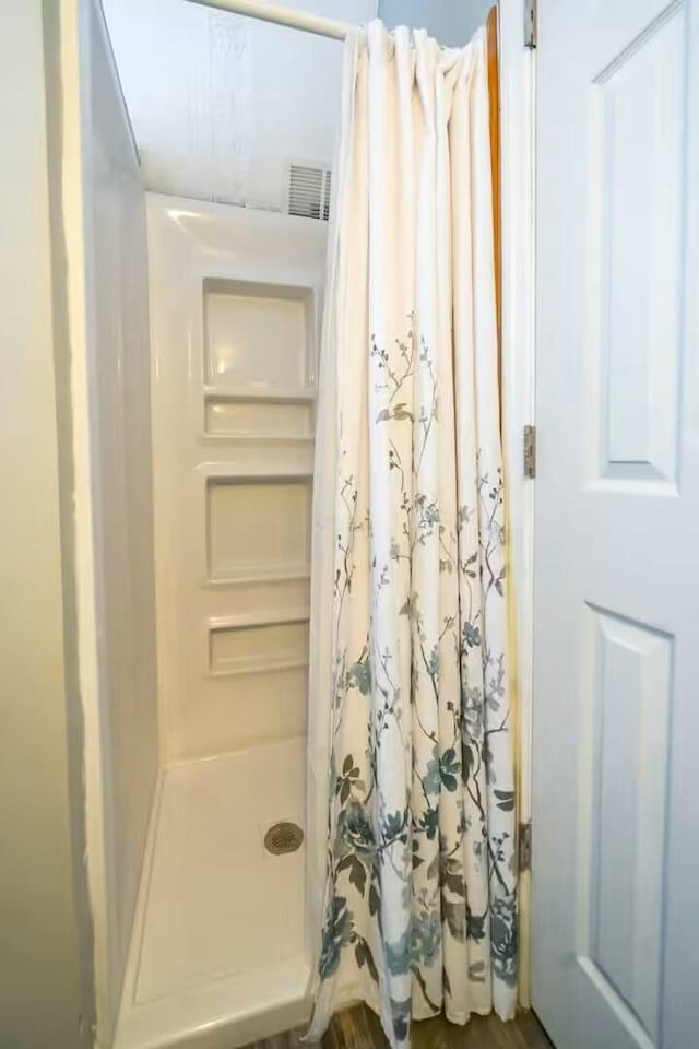 full bathroom with visible vents and a shower stall