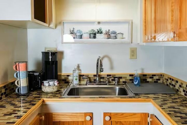 kitchen featuring tasteful backsplash and a sink