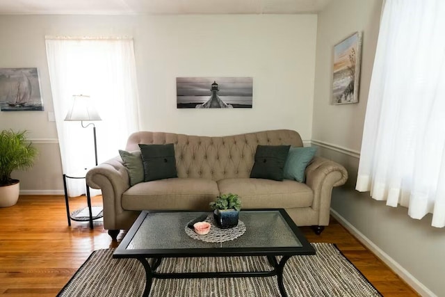 living area featuring baseboards and wood finished floors