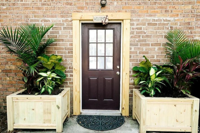 entrance to property with brick siding