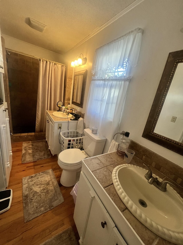 full bathroom with a shower with shower curtain, toilet, wood finished floors, and a textured ceiling