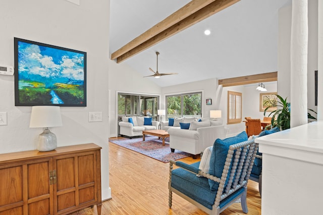 living room featuring beamed ceiling, high vaulted ceiling, light hardwood / wood-style flooring, and ceiling fan