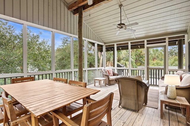 sunroom / solarium with ceiling fan and vaulted ceiling