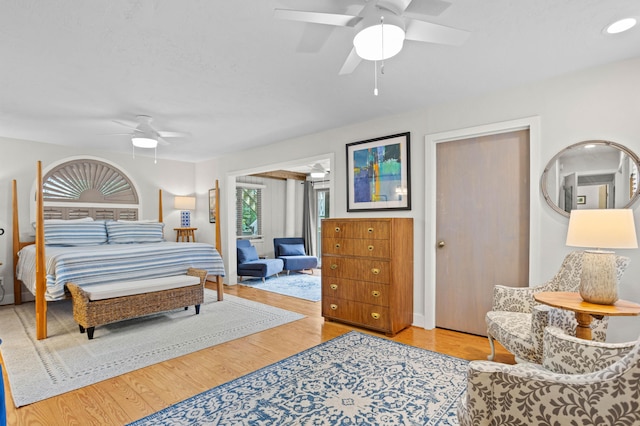 bedroom with ceiling fan and light hardwood / wood-style floors