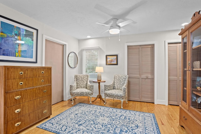 sitting room with light hardwood / wood-style flooring and ceiling fan