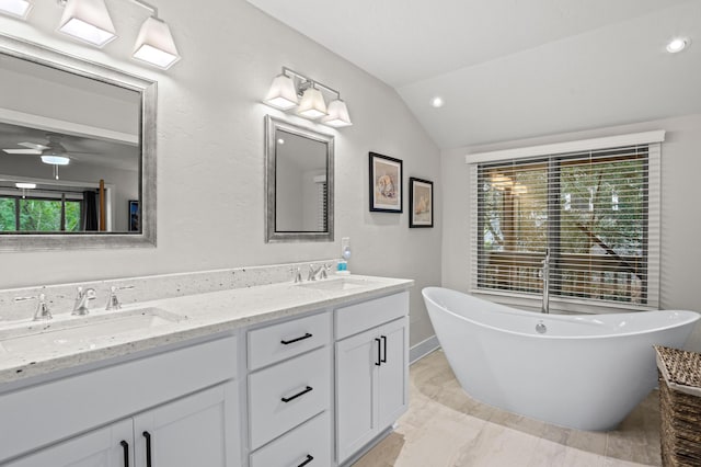 bathroom featuring a washtub, ceiling fan, plenty of natural light, and vaulted ceiling