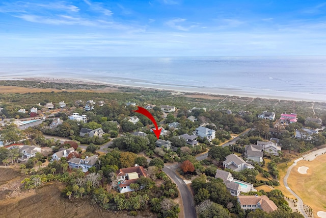 birds eye view of property with a beach view and a water view