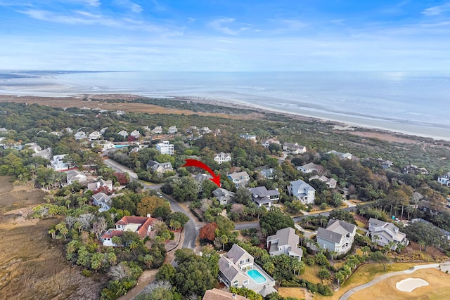 birds eye view of property featuring a water view and a beach view