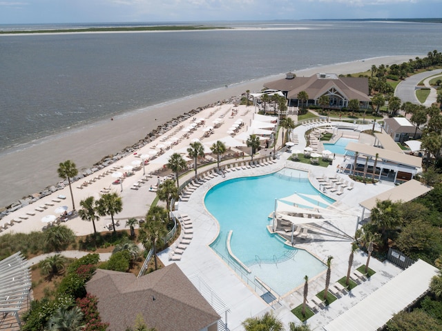 drone / aerial view featuring a water view and a view of the beach