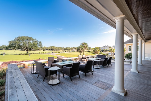 wooden terrace featuring a yard