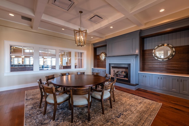 dining space featuring beamed ceiling, dark wood-type flooring, and an inviting chandelier