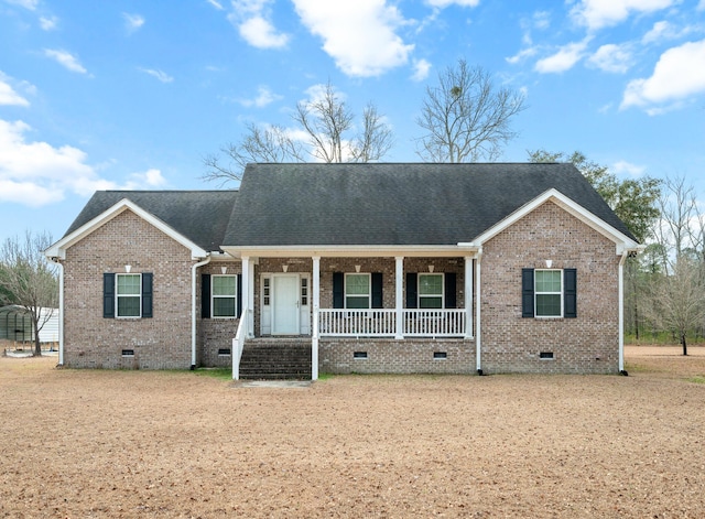 ranch-style house featuring crawl space, covered porch, brick siding, and roof with shingles