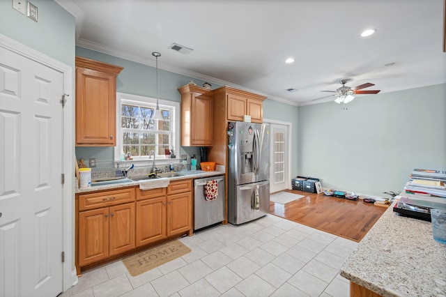 kitchen featuring visible vents, ornamental molding, decorative light fixtures, stainless steel appliances, and a sink