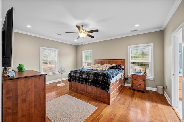 bedroom featuring ornamental molding, visible vents, and light wood-style floors