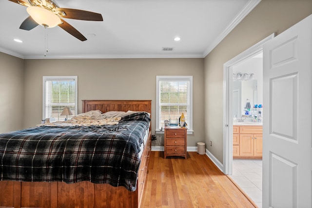 bedroom with light wood finished floors, multiple windows, visible vents, and crown molding