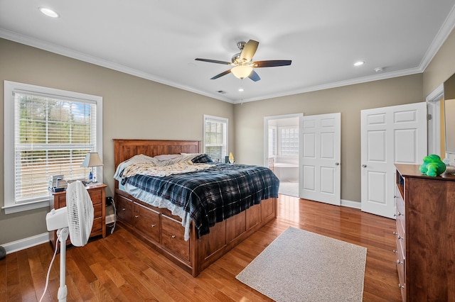 bedroom featuring ornamental molding, baseboards, and wood finished floors