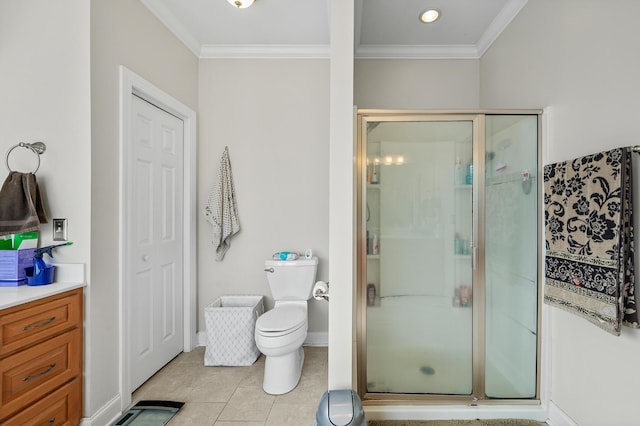 bathroom with tile patterned flooring, a shower stall, toilet, and crown molding