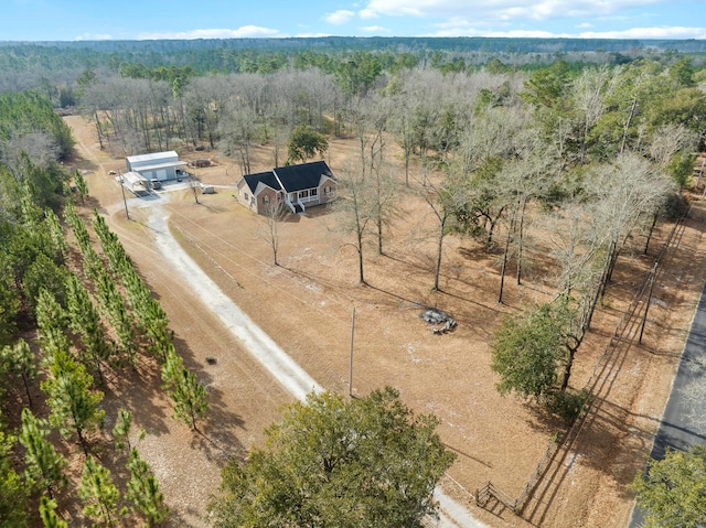 birds eye view of property with a view of trees and a rural view