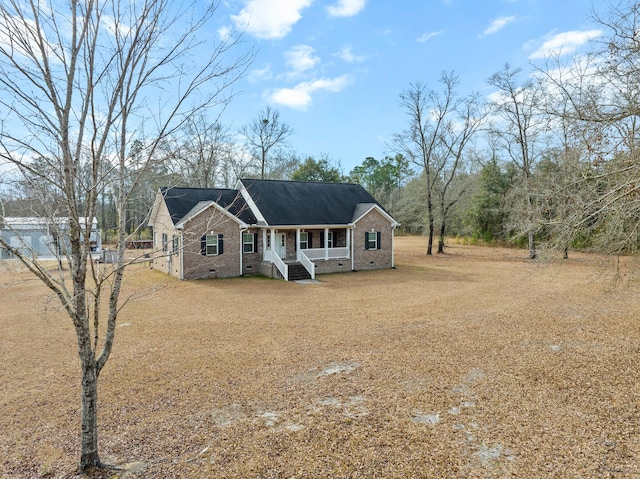 view of front facade with crawl space, covered porch, and brick siding