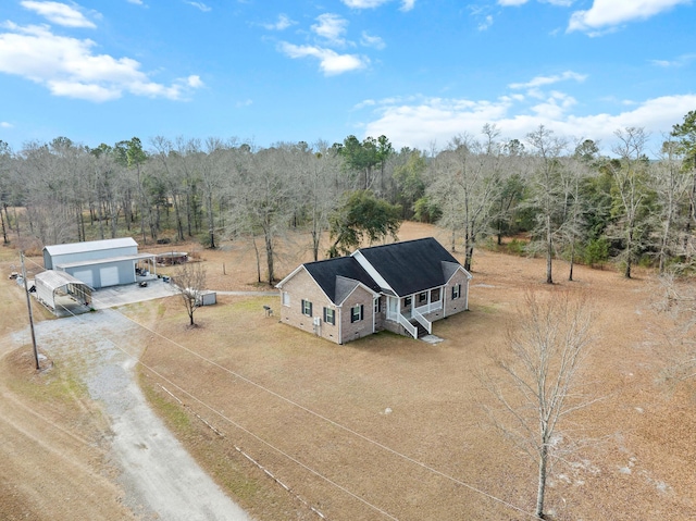 bird's eye view with a wooded view