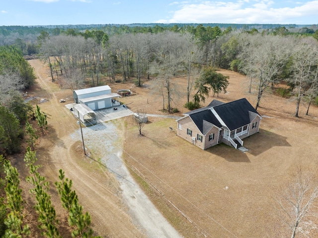 birds eye view of property with a rural view and a wooded view