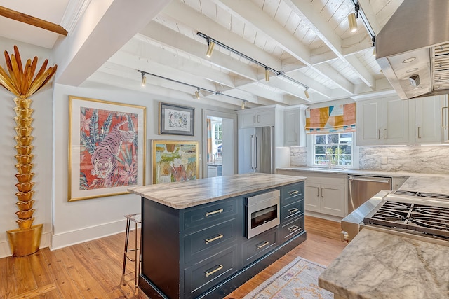 304 Bank St, Mount Pleasant, SC 29464 - kitchen with appliances with stainless steel finishes, rail lighting, white cabinetry, light wood finished floors, and wooden ceiling with exposed beams