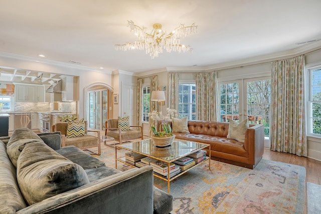 304 Bank St, Mount Pleasant, SC 29464 - living room with a chandelier, ornamental molding, light wood-style floors, arched walkways, and recessed lighting