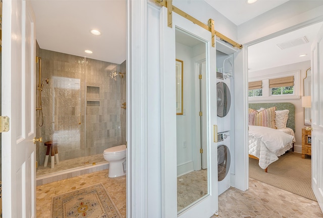 304 Bank St, Mount Pleasant, SC 29464 - bathroom with stacked washing machine and dryer, a shower stall, connected bathroom, recessed lighting, and toilet