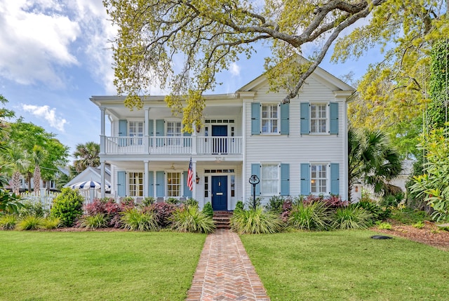 304 Bank St, Mount Pleasant, SC 29464 - view of front of house with a balcony, a front lawn, and a porch
