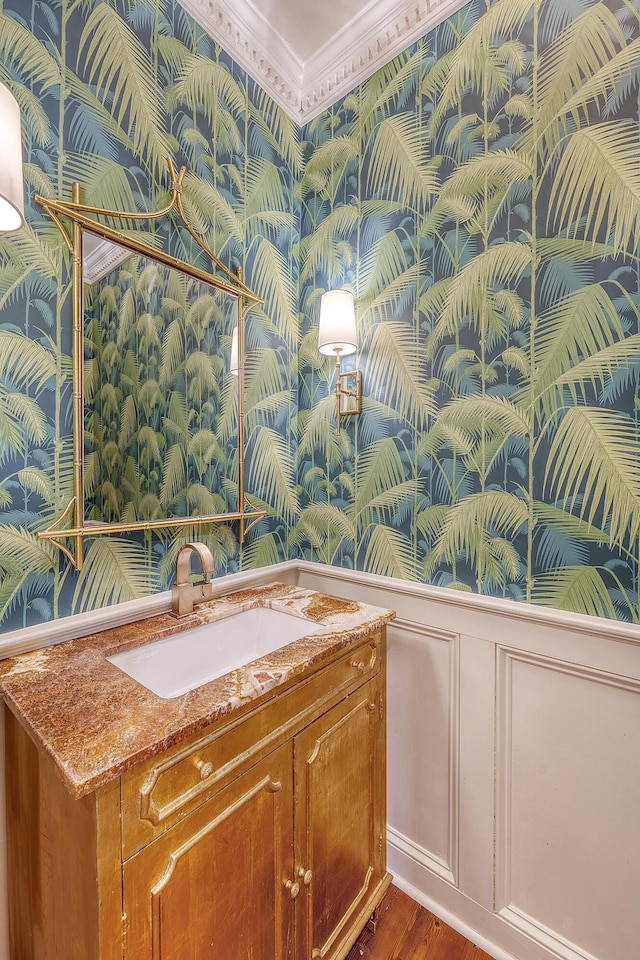 304 Bank St, Mount Pleasant, SC 29464 - bathroom with wallpapered walls, a decorative wall, vanity, wainscoting, and wood finished floors