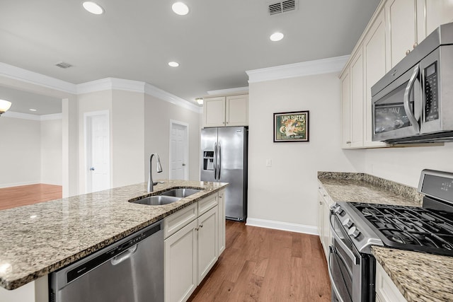 3310 Hartwell St, Johns Island, SC 29455 - kitchen featuring stainless steel appliances, a sink, wood finished floors, stone counters, and crown molding