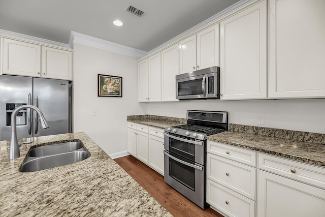 3310 Hartwell St, Johns Island, SC 29455 - kitchen with appliances with stainless steel finishes, ornamental molding, a sink, dark wood finished floors, and light stone counters
