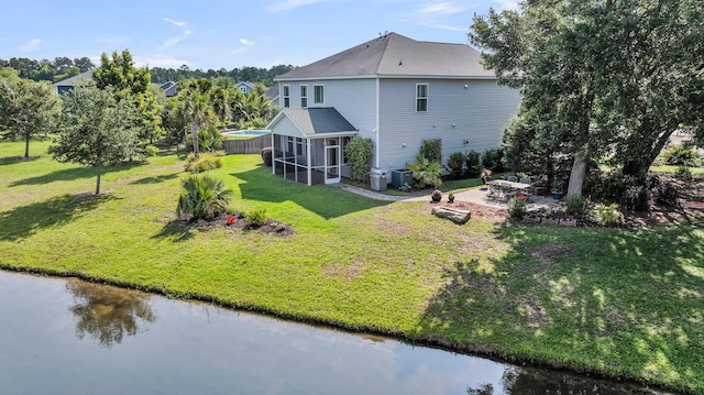 3310 Hartwell St, Johns Island, SC 29455 - back of property with a sunroom, a patio area, a lawn, and a water view