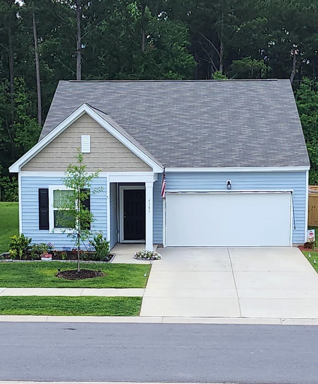 view of front of house with a front lawn and a garage