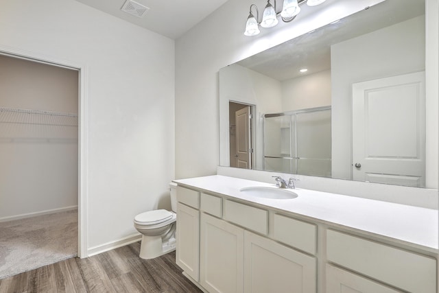 bathroom with wood-type flooring, vanity, and toilet