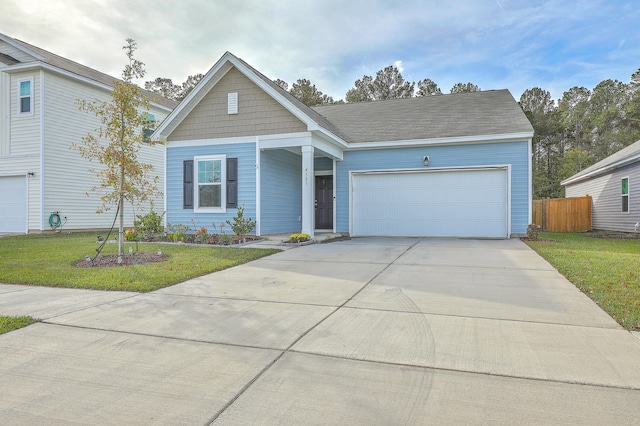 view of front of home featuring a front yard and a garage