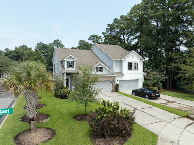 view of front of house with a front yard and a garage