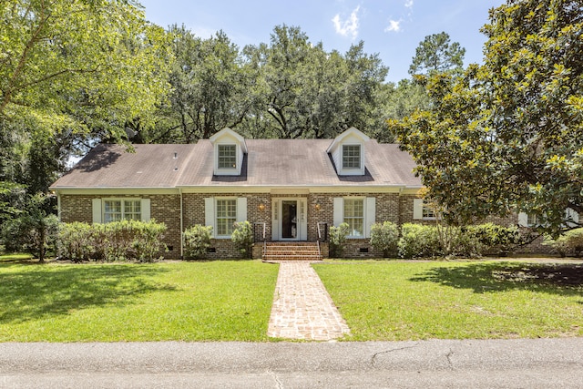 cape cod-style house with a front lawn