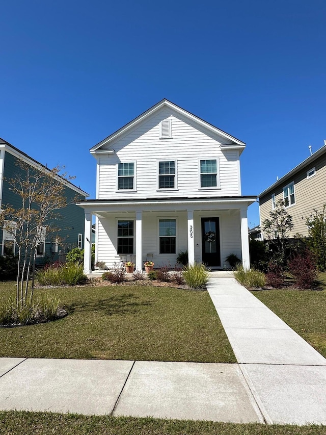 view of front facade with a front yard and covered porch