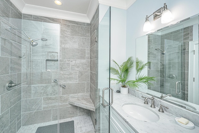 bathroom featuring vanity, crown molding, and a shower with shower door