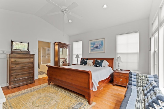 bedroom with ensuite bath, ceiling fan, multiple windows, and light hardwood / wood-style flooring